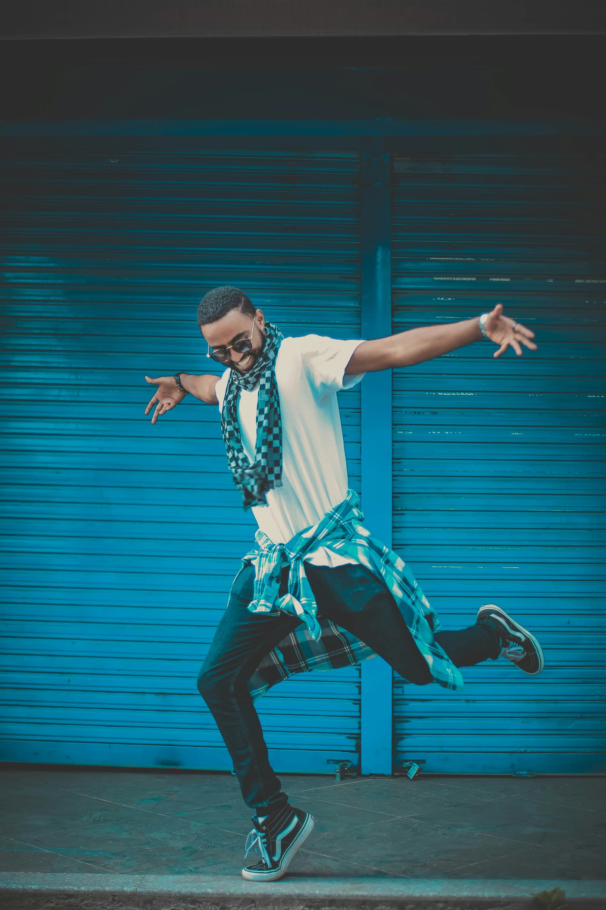 A dancer mid-leap against a bright wall