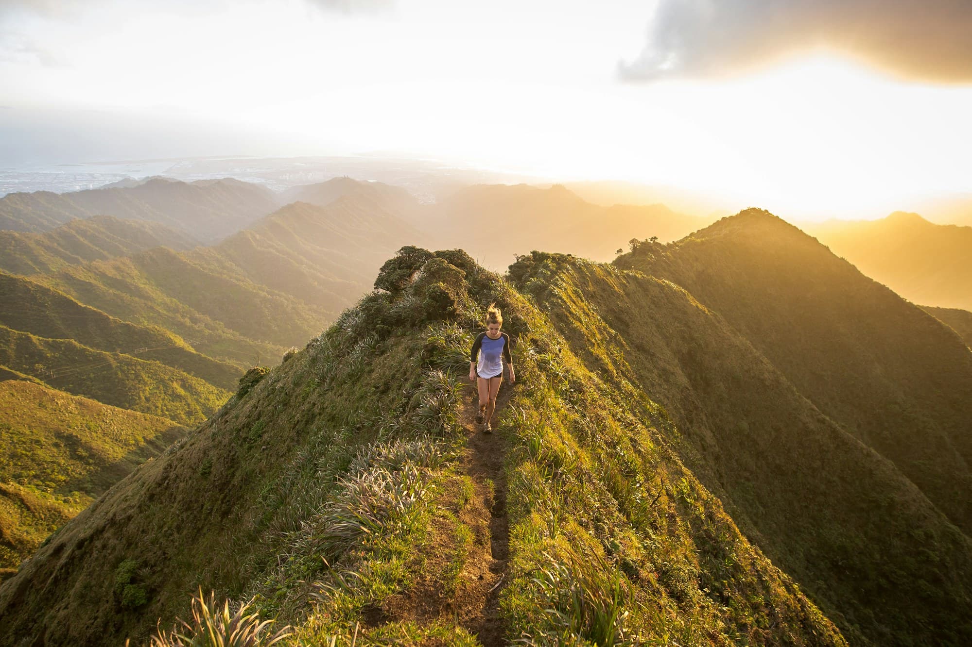 A walker on a mountain ridge at sunrise
